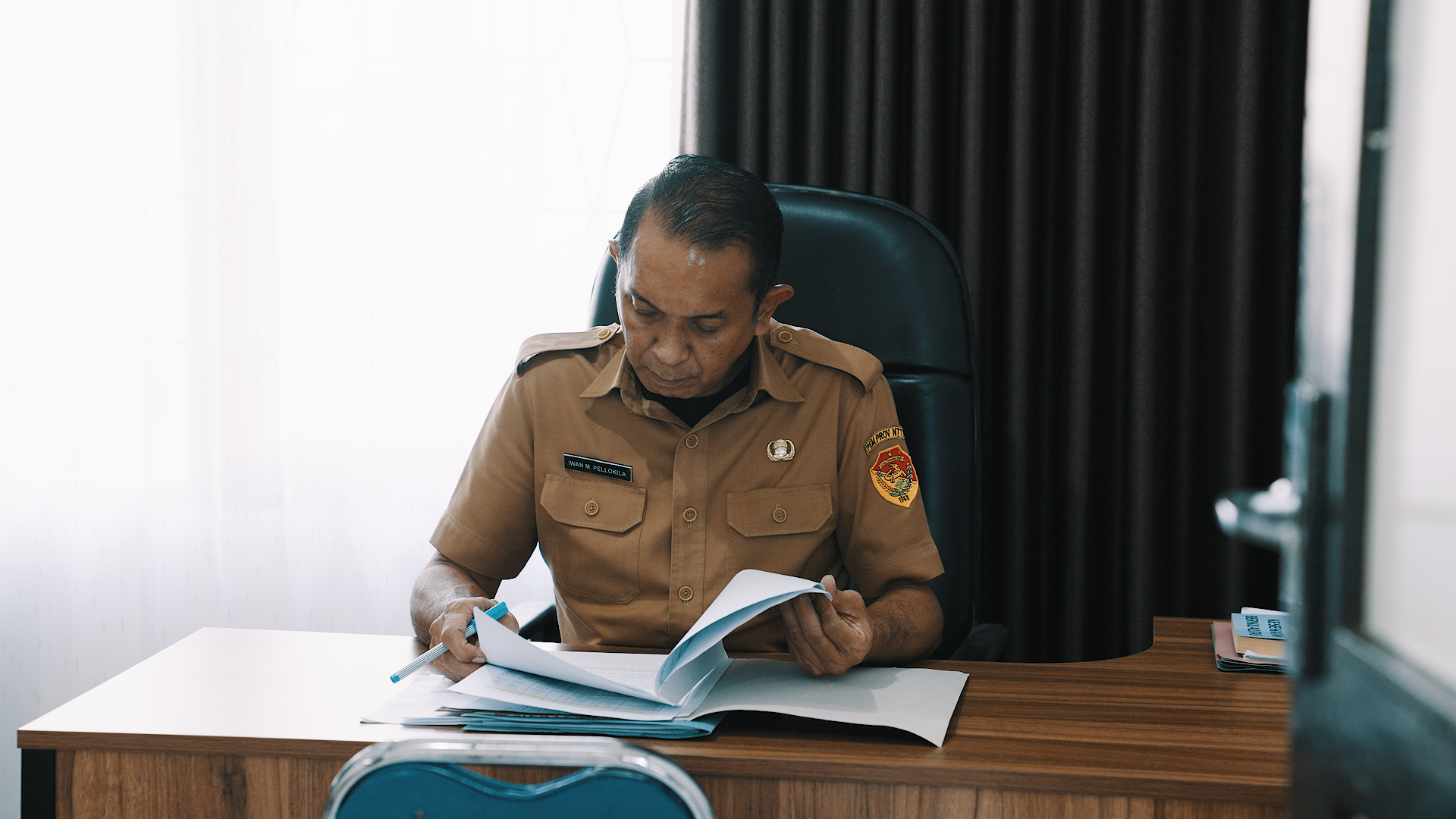 Man in uniform working at desk