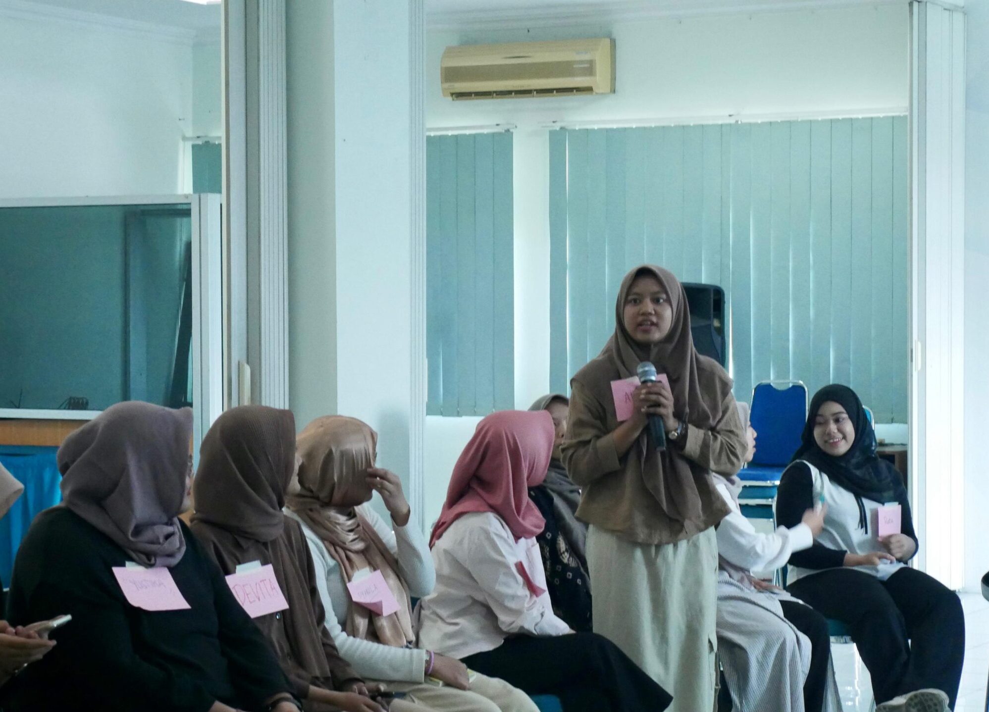 girl standing in crowd and speaking - ipas