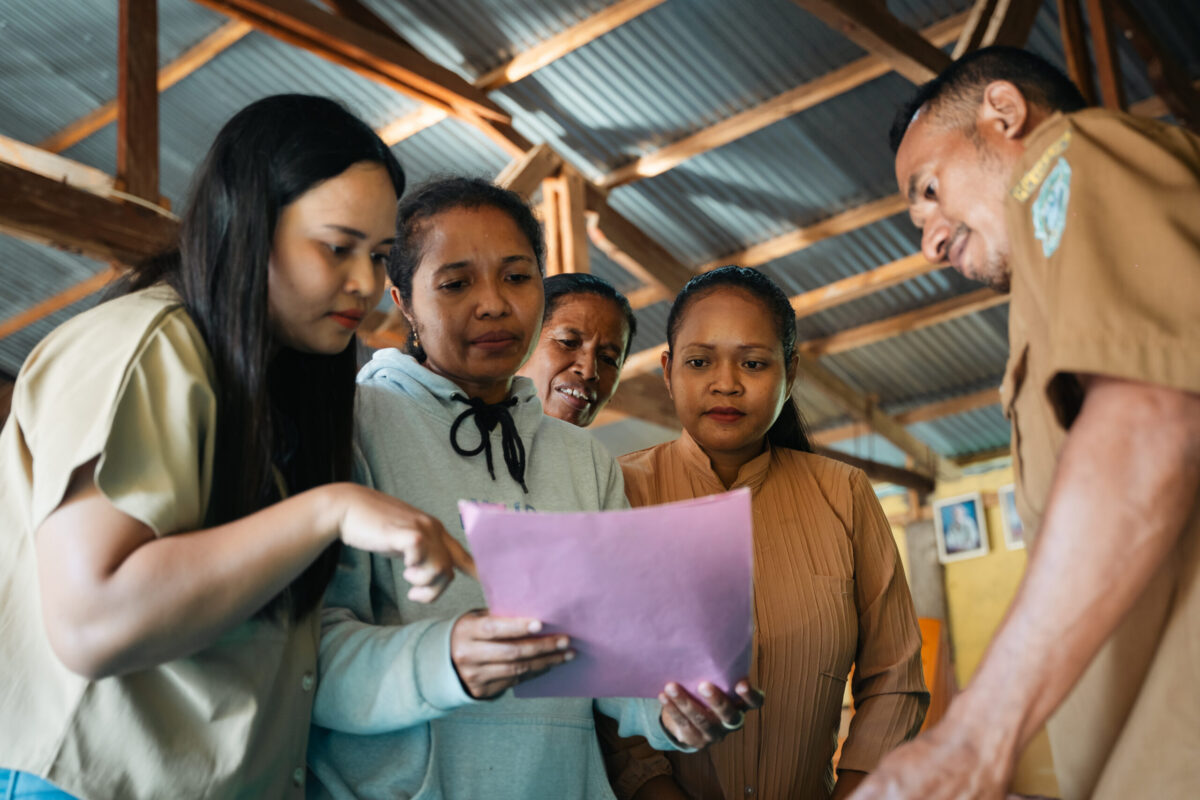Group of healthcare workers looking at a sheet of paper