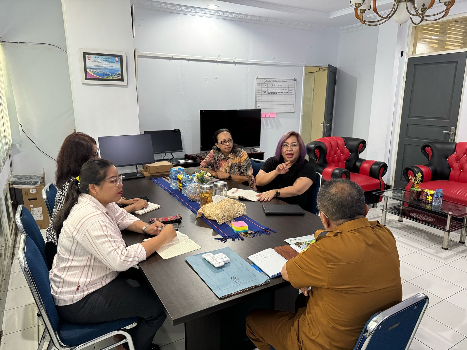Group of people working around a table.