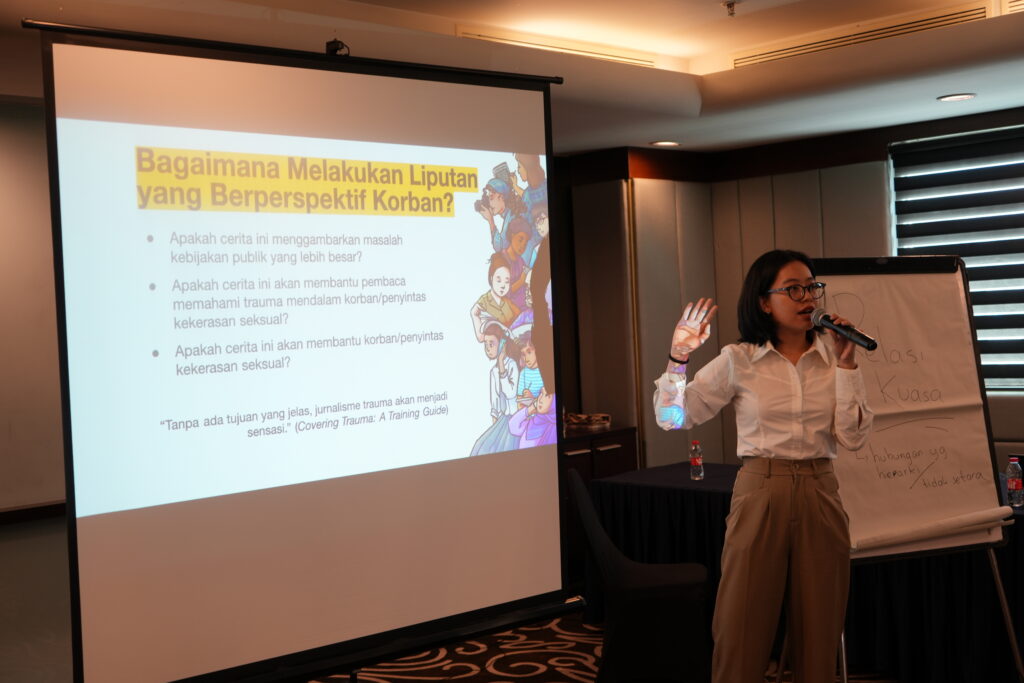 A woman presenting something to a group of people.